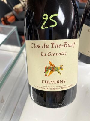 three bottles of wine sitting on a counter in a store