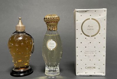 two bottles of perfume sitting next to each other on a table