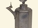 a metal tea pot with a handle on a white background