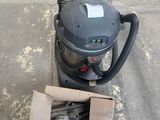 a box of tools sitting on the sidewalk next to a vacuum
