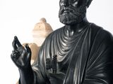 a statue of a man sitting on a chair