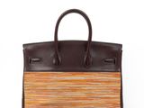 a brown and orange striped handbag on a white background