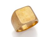 a close up of a gold ring on a white surface