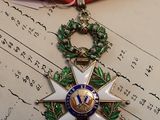 a medal on a red ribbon on top of a piece of paper