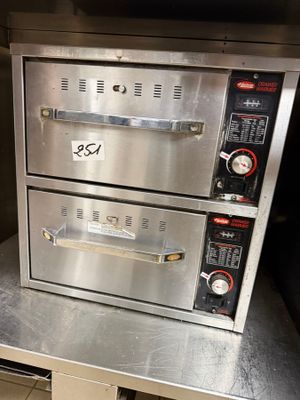 two ovens sitting on top of each other in a kitchen