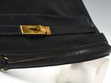 a close up of a black purse with a gold buckle