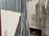 a pile of metal pipes in front of a building