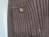 a close up of a sweater with a button on it