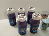 six bottles of trifect sit on a counter top next to a jar of pills