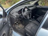 the interior of a car with the door open and the driver ' s seat down