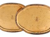 pair of antique gold plated trays on a white background