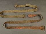 three belts are lined up on a table with a metal clasp