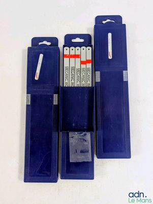 trois piles bleues sont alignées sur une surface blanche