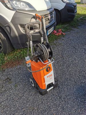 a small orange and white machine that is on the side of the road