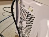 a white microwave with a black cord attached to it