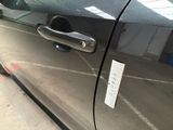 a close up of a car door handle with a sticker on it