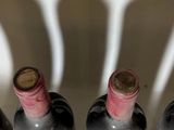 bottles of wine are lined up in a row on a counter