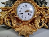 a gold clock that is sitting on a table