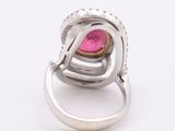 a close up of a ring with a pink stone in it