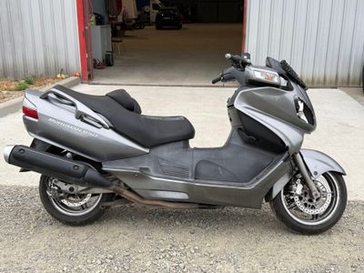 a motorcycle that is parked in front of a garage