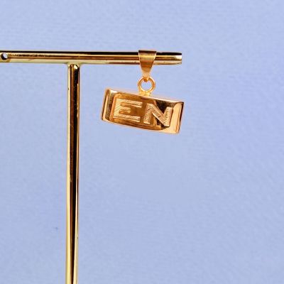 a gold plated necklace that has a sign on it