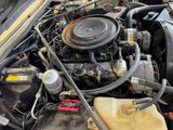 a picture of a car engine with its hood open