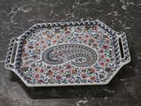 a tray with a paisley design on it on a table