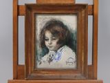 painting of a young girl in a white dress in a wooden frame