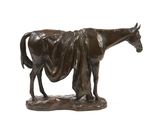 a bronze statue of a horse with a blanket on it ' s back