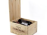 a wooden box with a bottle of wine inside of it