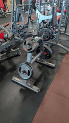 a gym with a lot of machines in the room