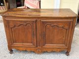 a wooden cabinet with a door on top of it