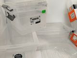 many plastic containers with lids on a white counter