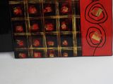 a red box with black and gold designs on it