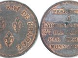 a close up of a coin on a white surface