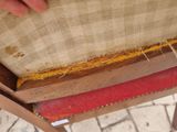 a person that is sitting on a chair with a piece of fabric on it