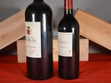 two bottles of wine sitting next to each other on a table