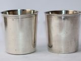 pair of silverplated shot glasses on a white background