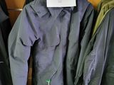 a lot of coats hanging on a rack in a store