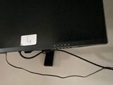 a flat screen tv mounted on the wall above a bed