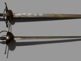 pair of old and worn swords on a gray surface