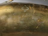 a close up of a brass plate with writing on it