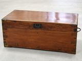 a wooden chest with a metal latch on it