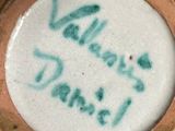 a yellow and green vase with writing on it