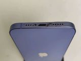 the back of a purple iphone with a small hole in the middle of it