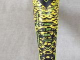 a hand holding a baseball bat with a yellow and black design