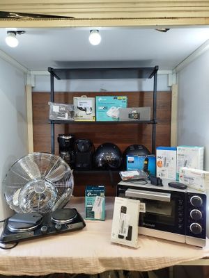 a microwave and a fan on a table in a room