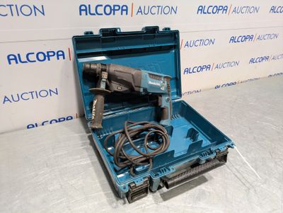 an electric drill in a blue case with a cord in it
