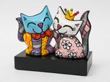 two figurines of a cat and a cat with a crown on their heads