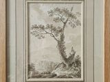 une vieille photo représentant un arbre dans un paysage, avec un homme assis à son pied